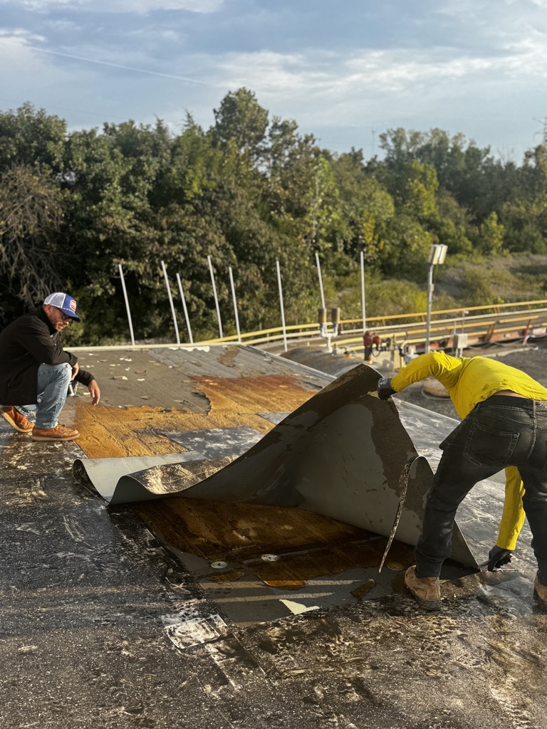 Crew working on a flat roof tear-off